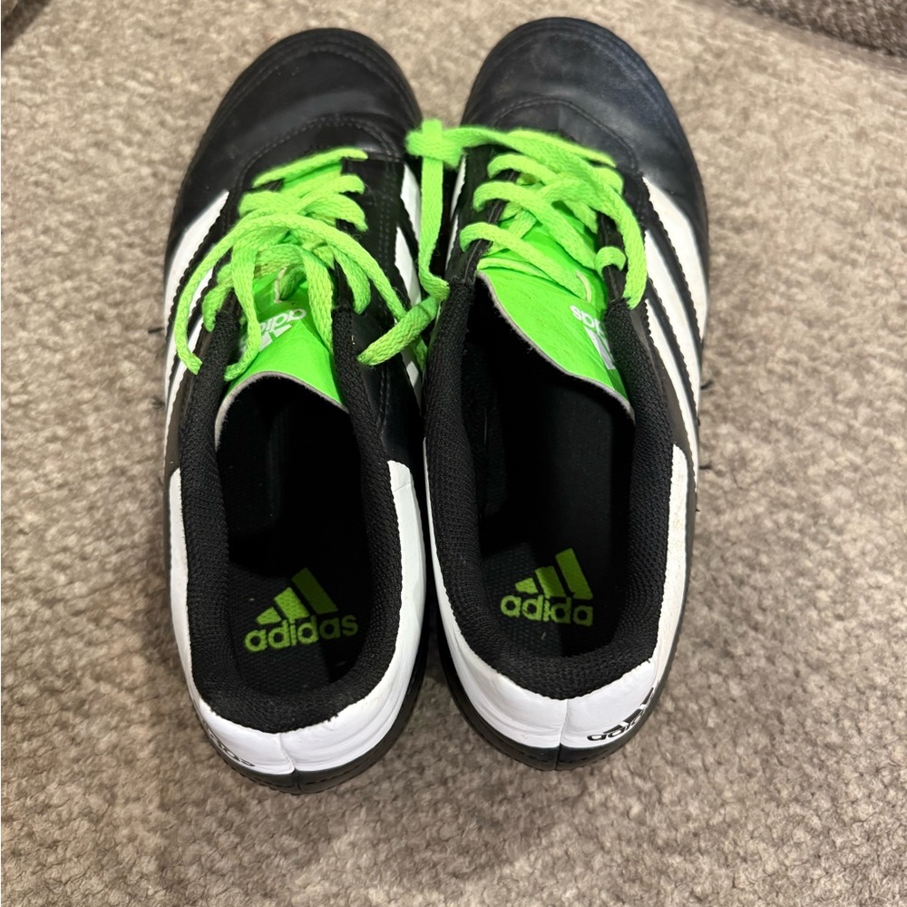 Adidas Black and White Cleats with Green Accents